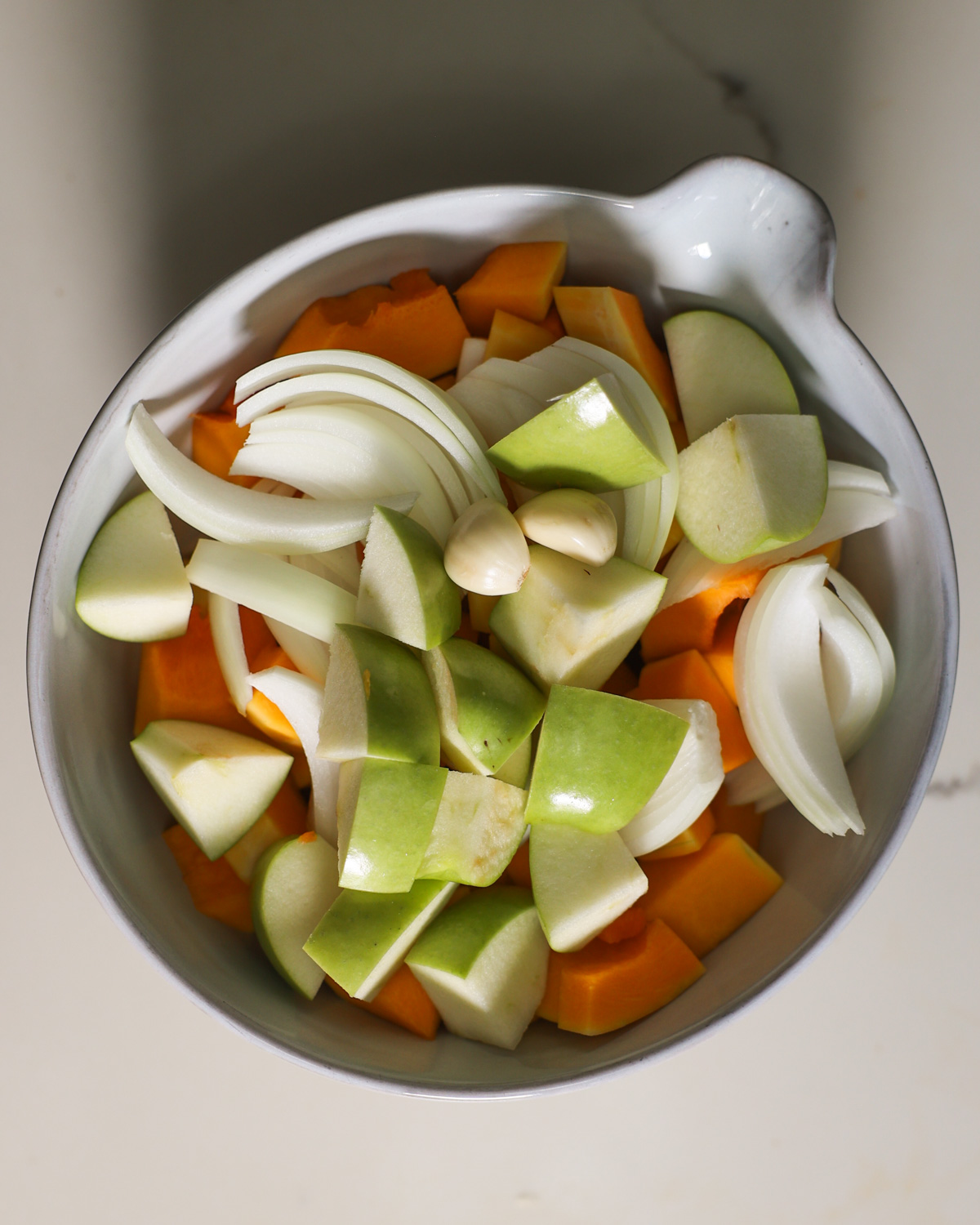 overhead of butternut squash and apples in bowl