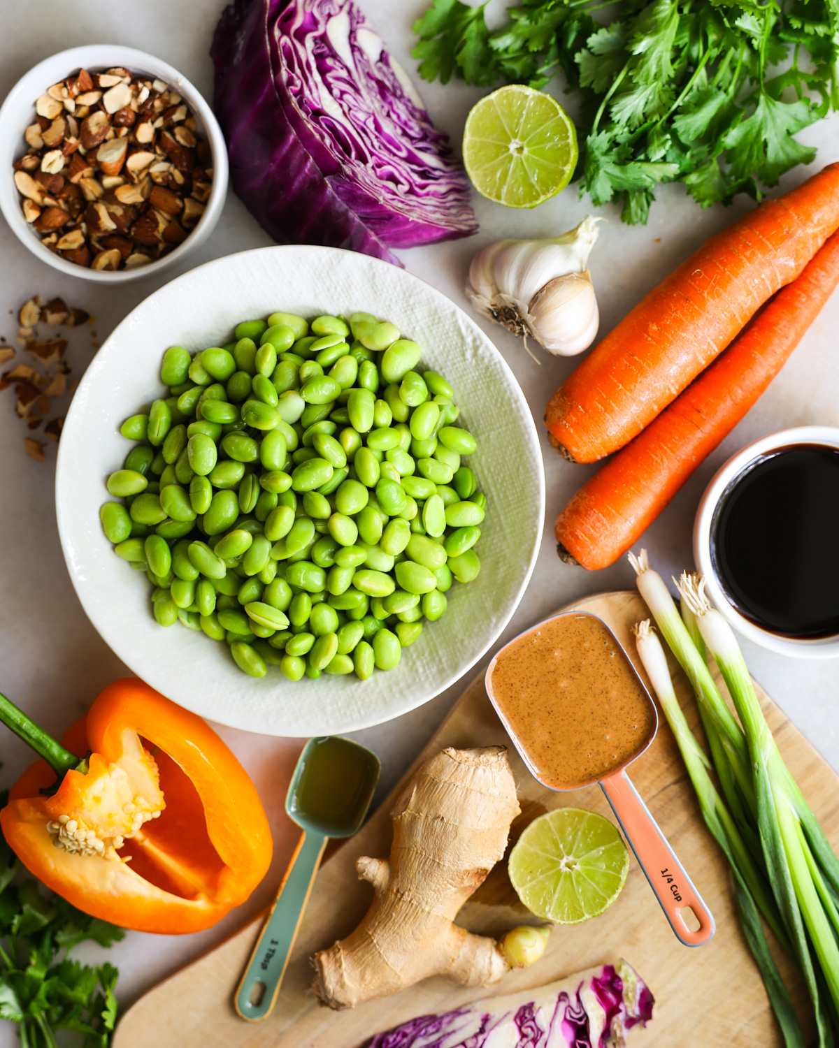 All of the ingredients to make edamame salad on the counter.