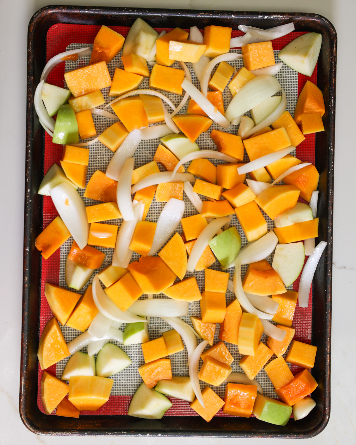 overhead of squash and apples on pan