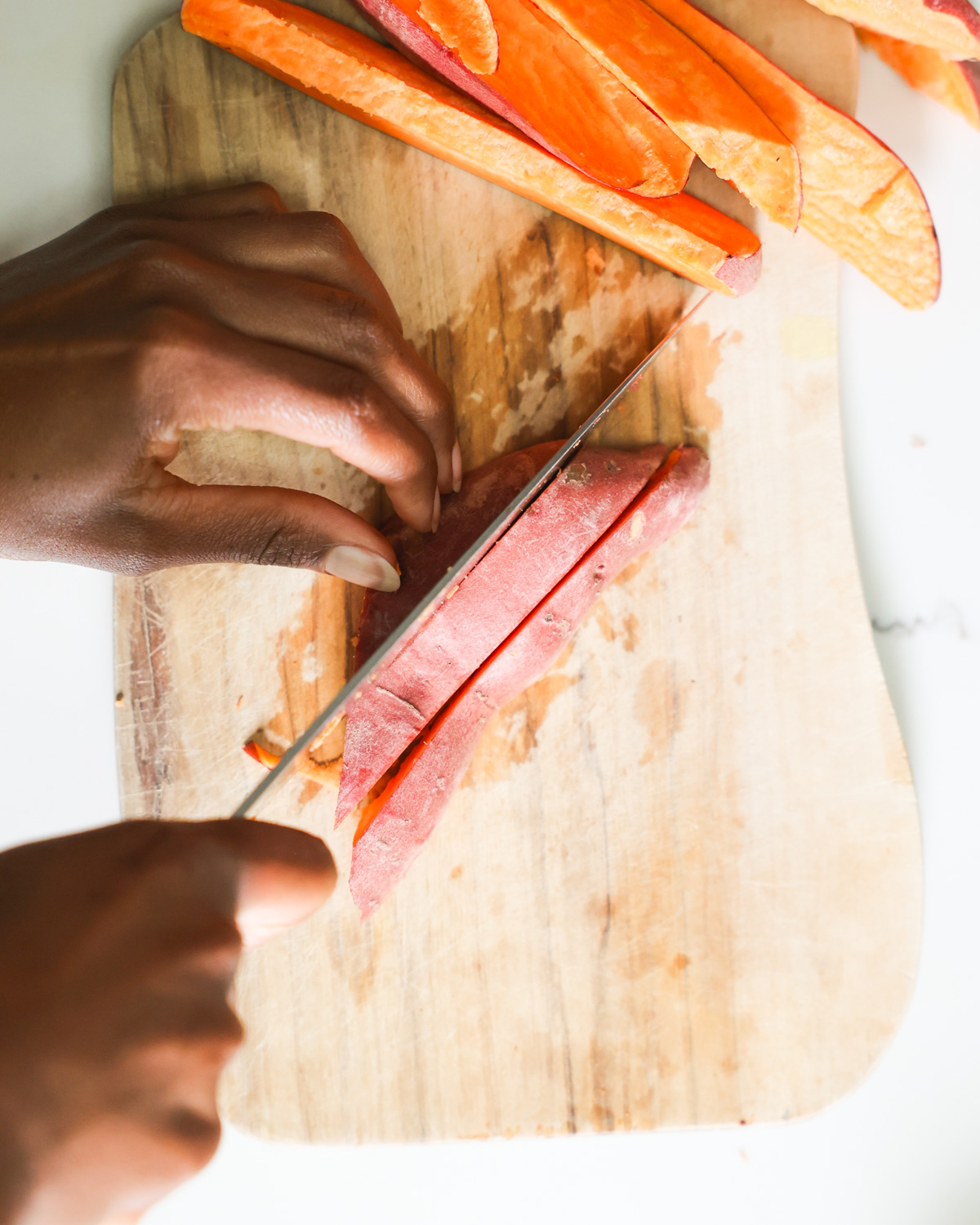 Cutting sweet potatoes into wedge shape