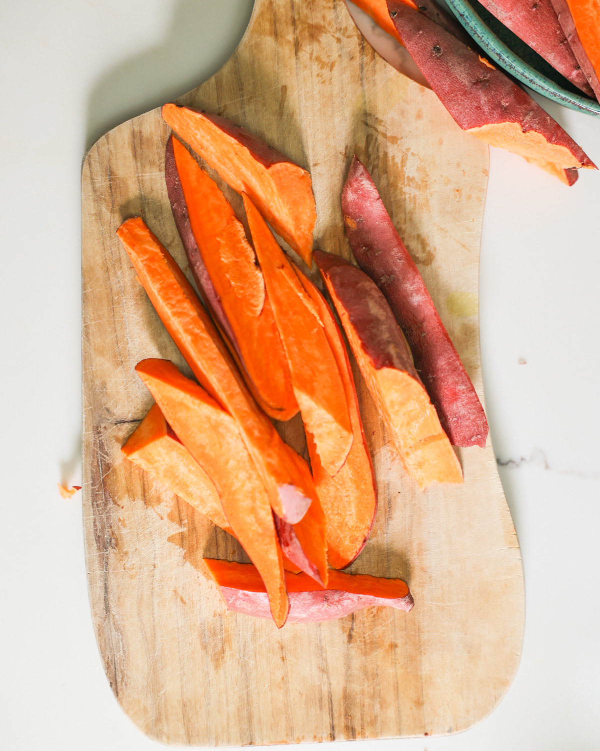 sliced sweet potatoes on a cutting board