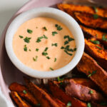 overhead of gochujang aioli with sweet potato wedges