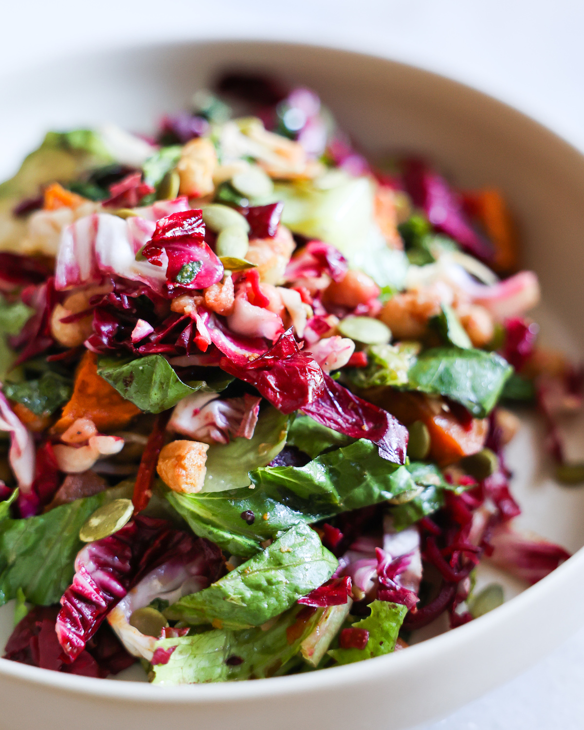 A close-up shot of a bowl of the autumn kale salad.