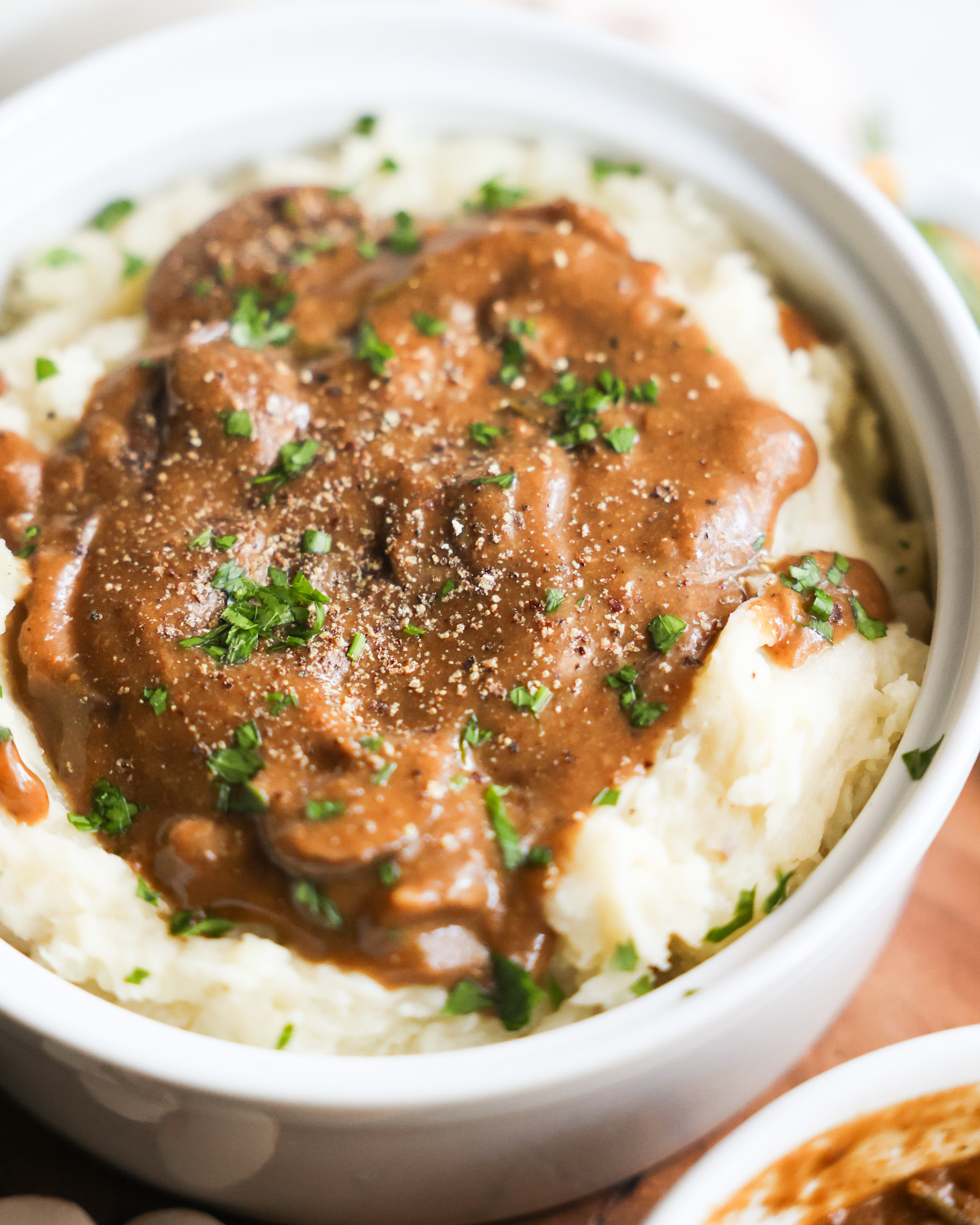 closeup of vegan mashed potatoes topped with mushroom gravy