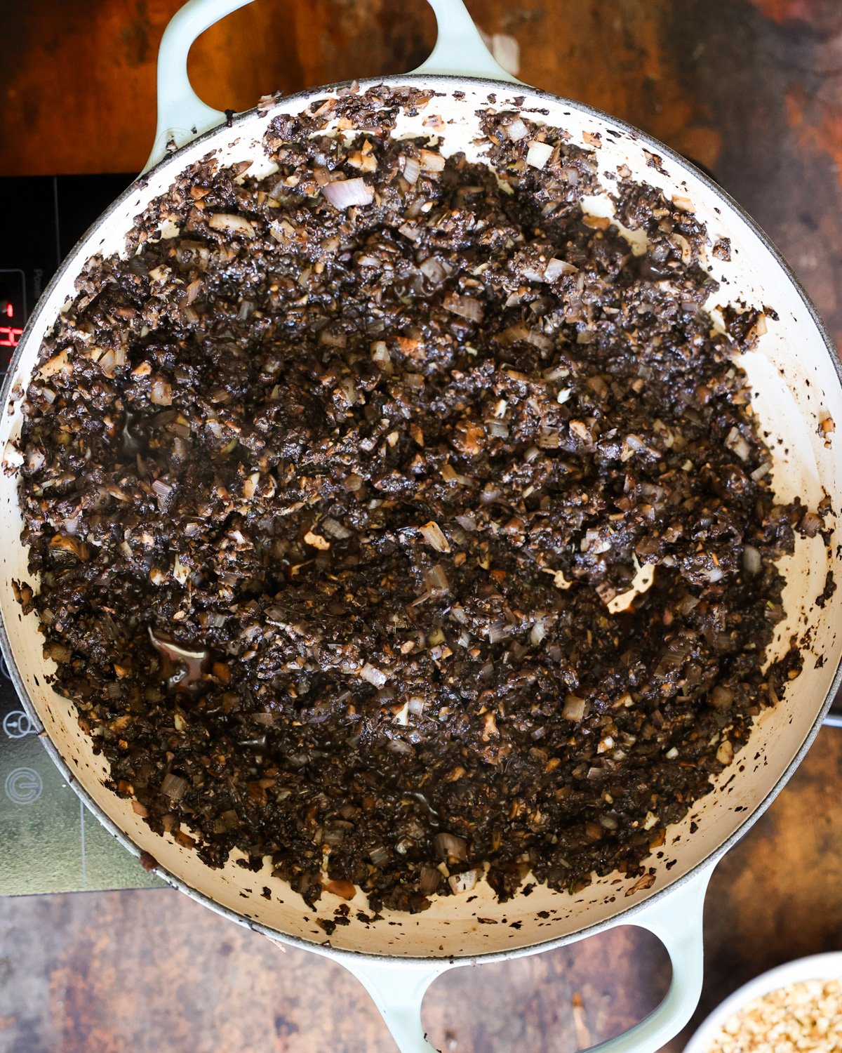 An overhead shot of the cooked mushroom filling in a pan.