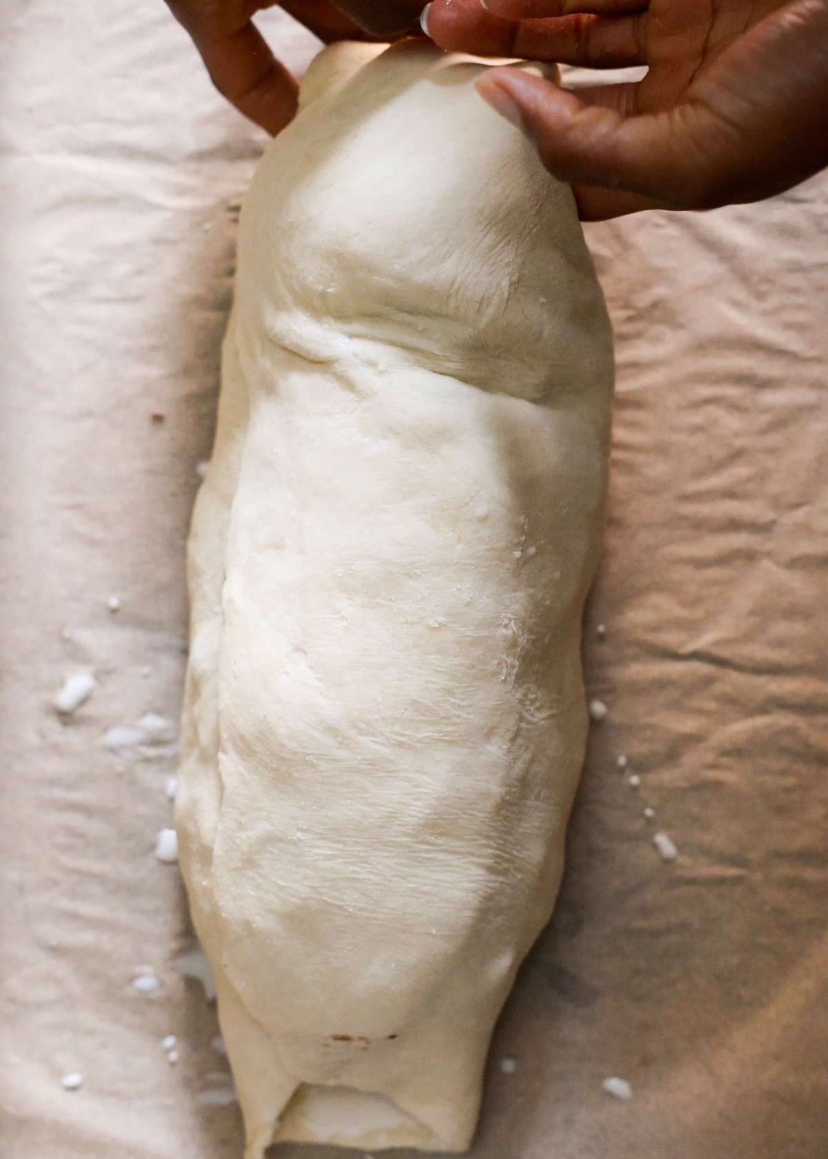 Turning the pastry ends under the mushroom Wellington.