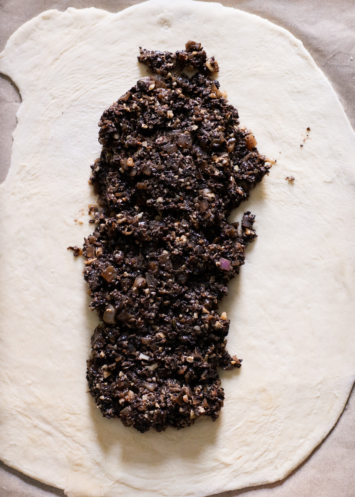 The mushroom filling spread down the center of the rolled pastry.