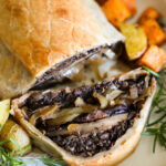 A close up shot of the baked mushroom Wellington with a slice taken out of it.