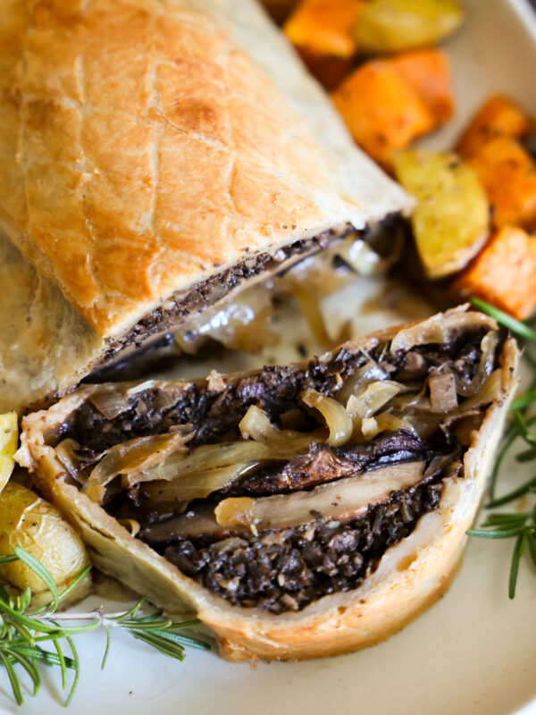 A close up shot of the baked mushroom Wellington with a slice taken out of it.