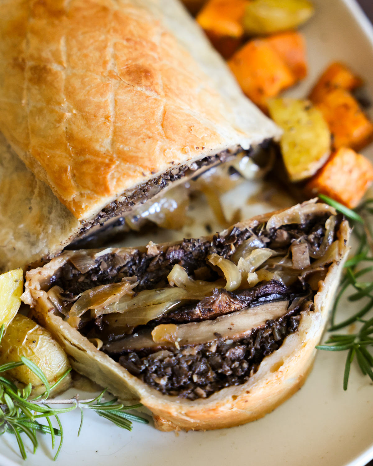 A close up shot of the baked mushroom Wellington with a slice taken out of it.