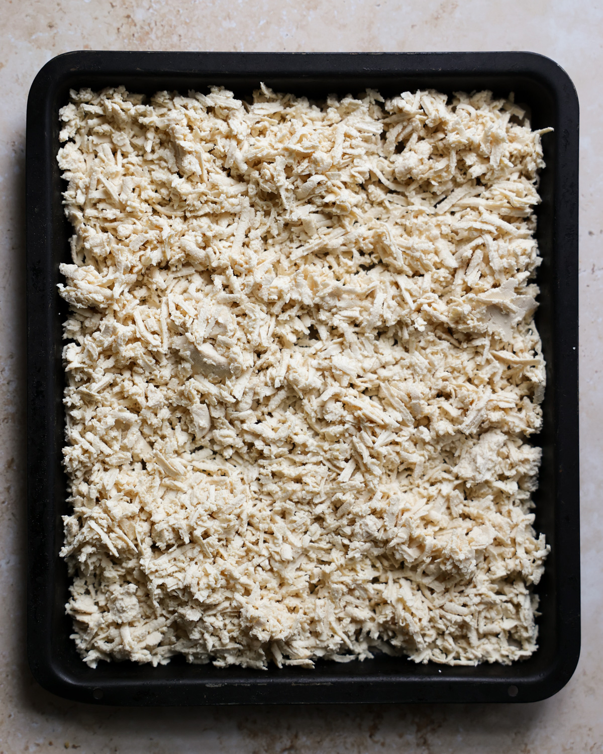 overhead shredded tofu on baking sheet