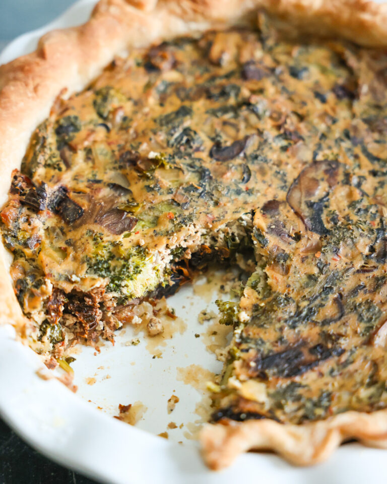 closeup on vegan quiche with missing slice