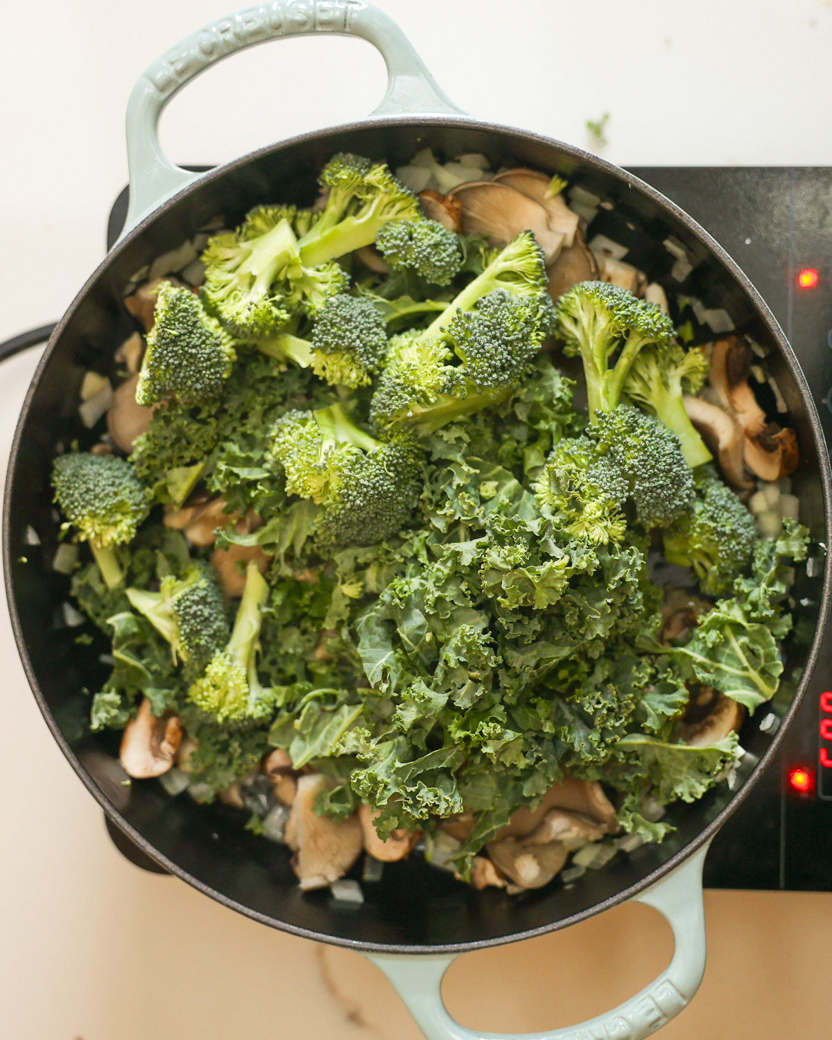 overhead sautéing kale and broccoli