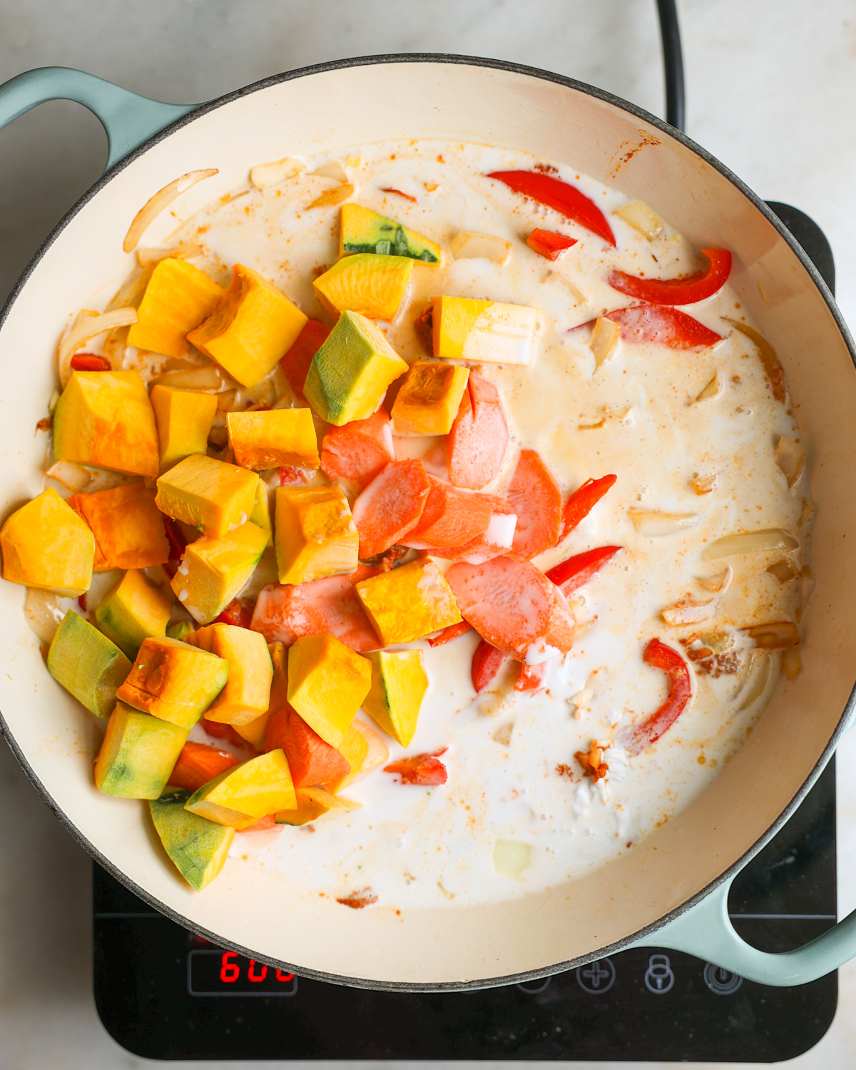 overhead of vegetables added to the pan