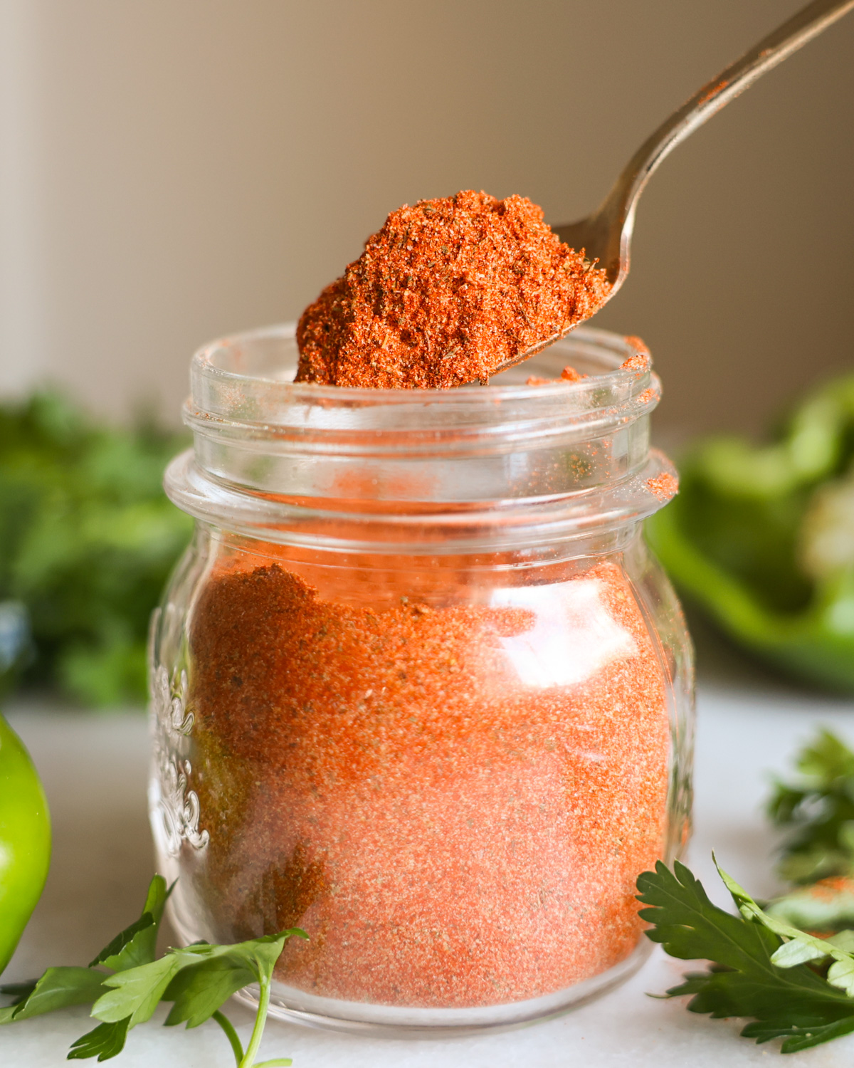 scoop of creole seasoning in a jar