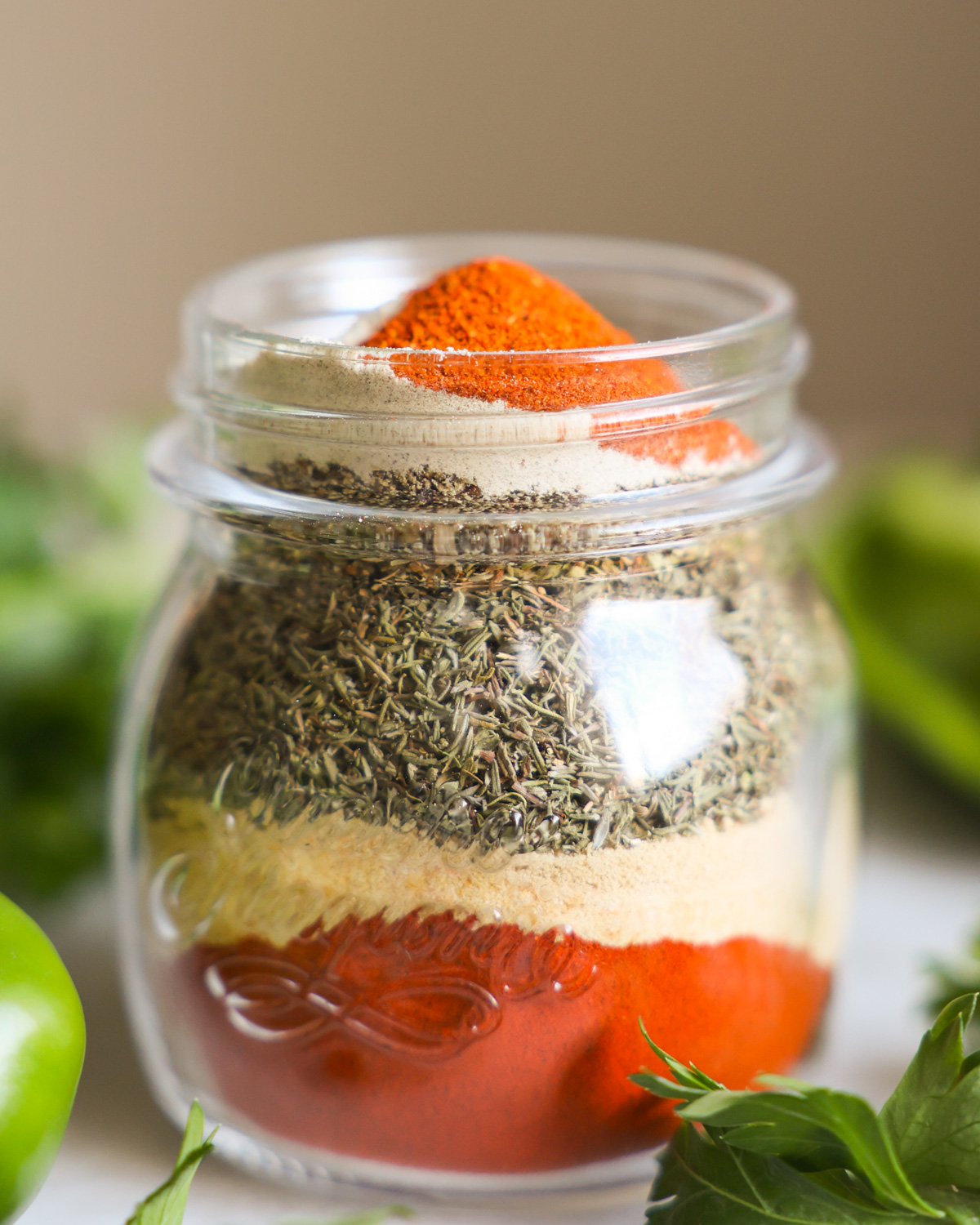 creole seasoning ingredients stacked in jar