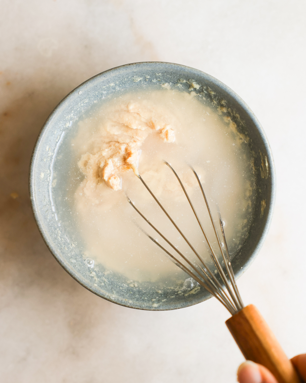 overhead of whisking tahini dressing