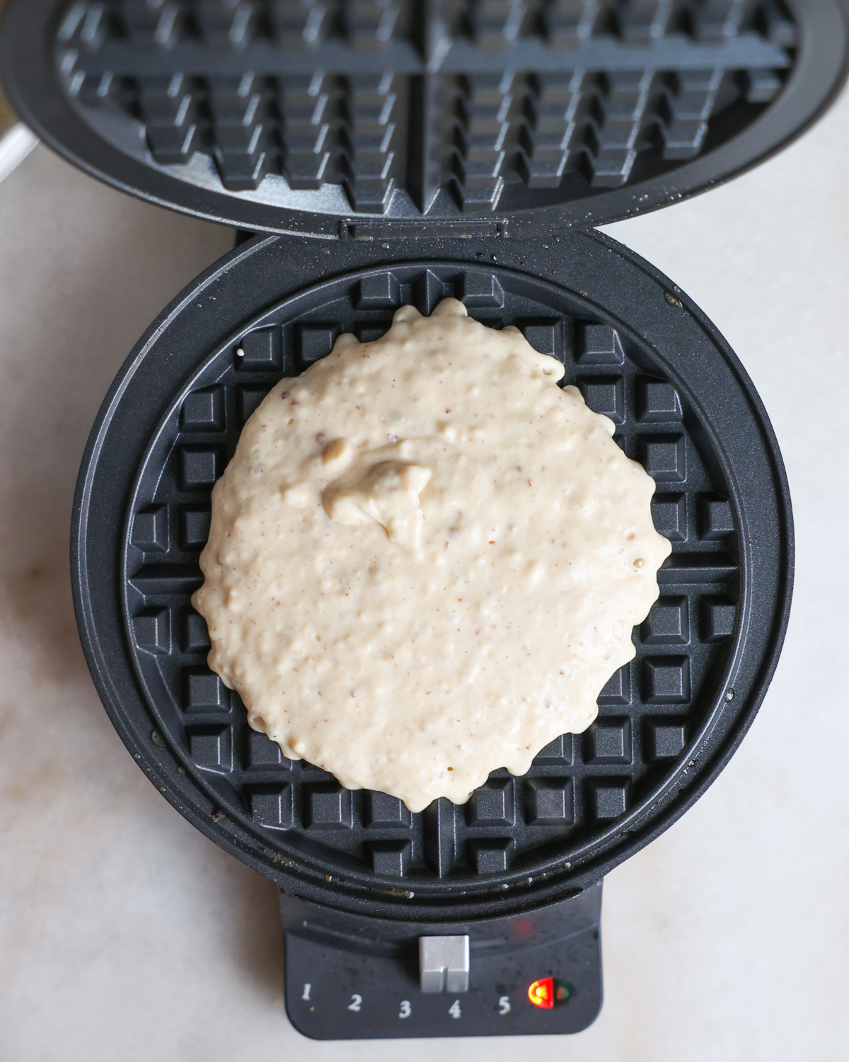 overhead batter in waffle iron