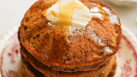 vegan sweet potato pancakes topped with maple syrup