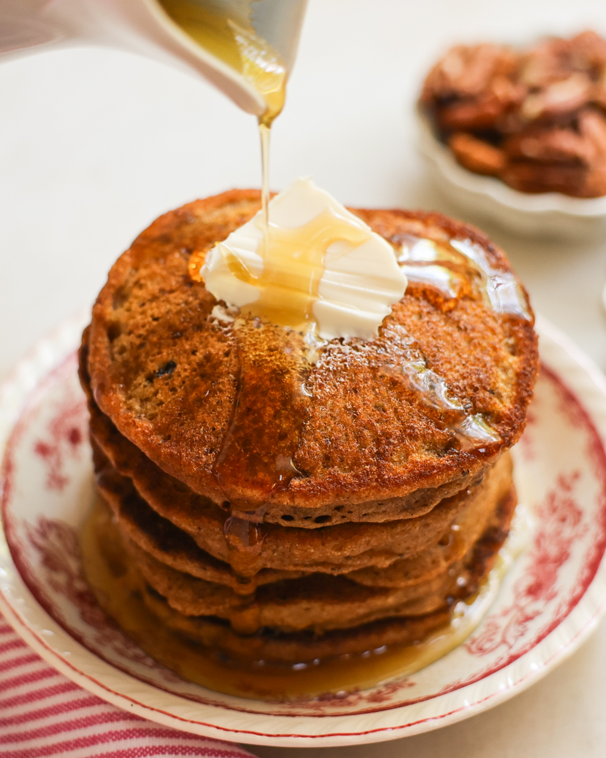 vegan sweet potato pancakes topped with maple syrup