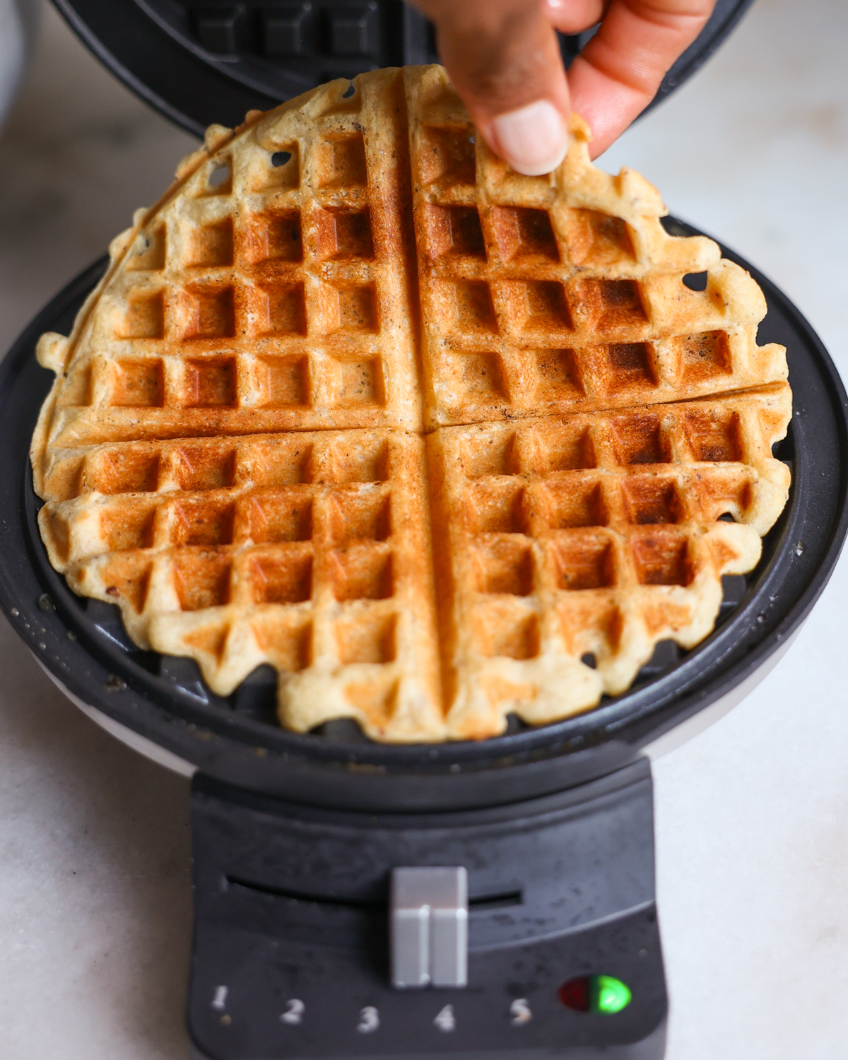 Vegan waffle in iron.