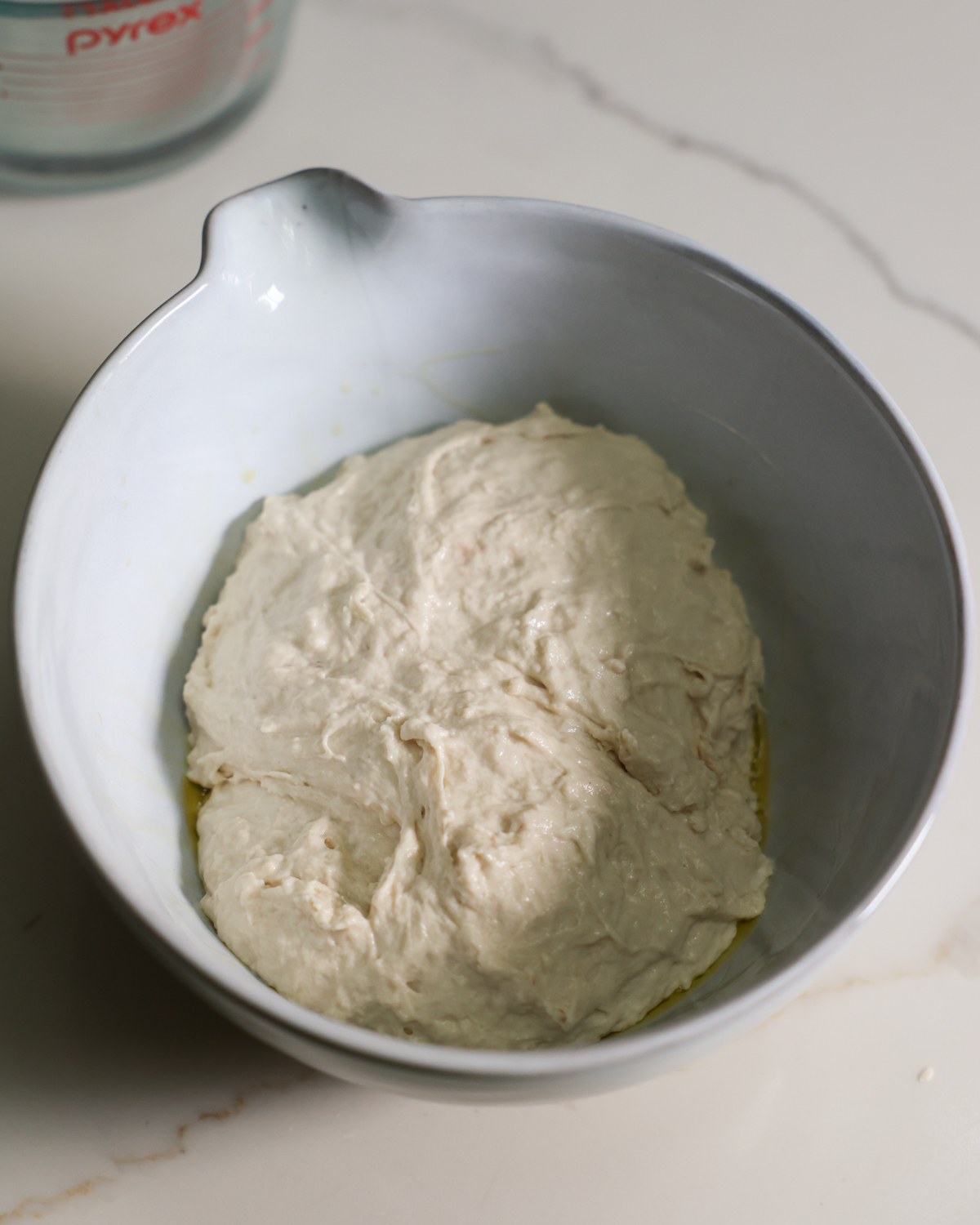 overhead of dough resting in bowl