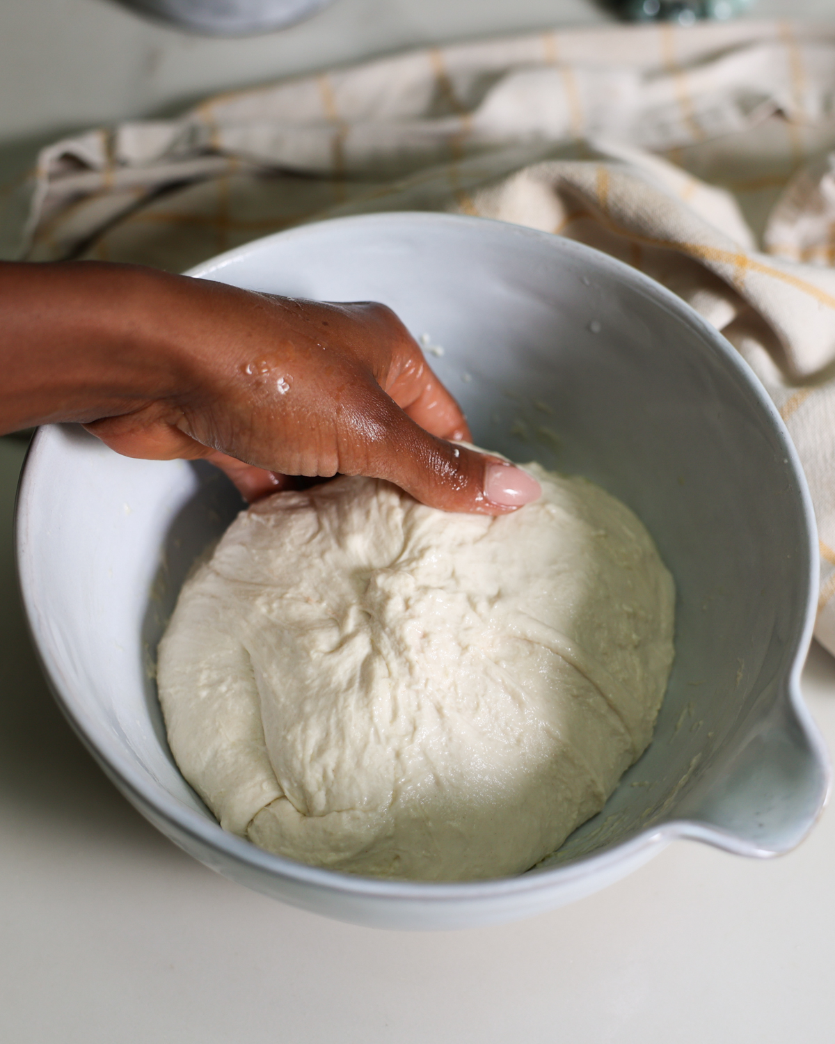 scooping dough to fold
