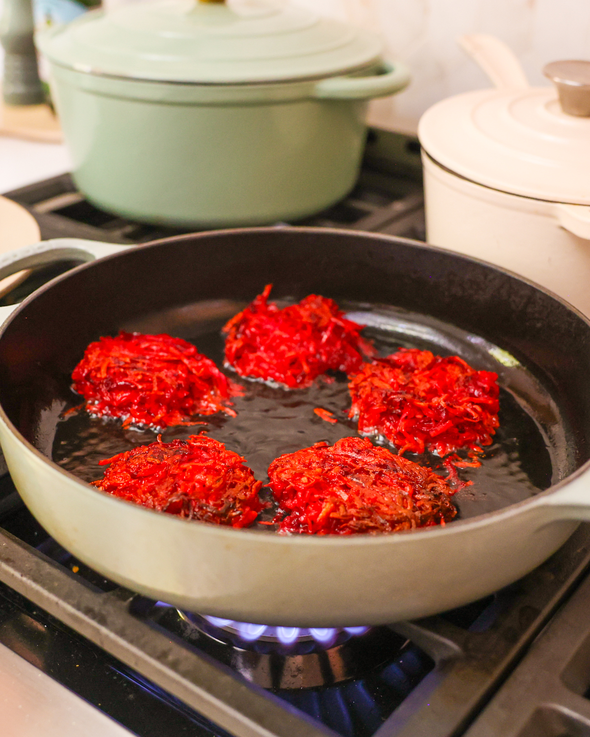 sweet potato fritters frying in skillet