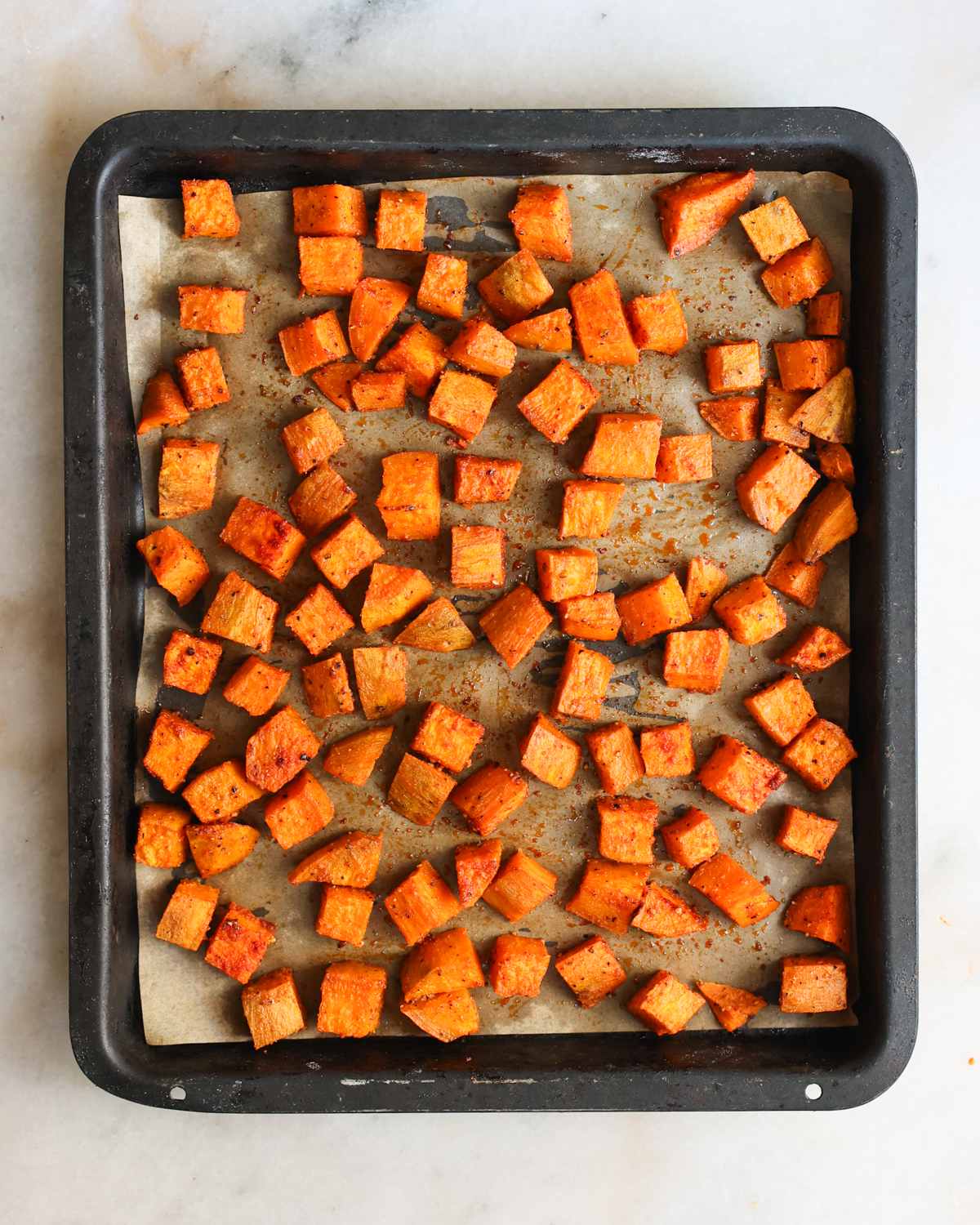 overhead roasted sweet potatoes on baking sheet
