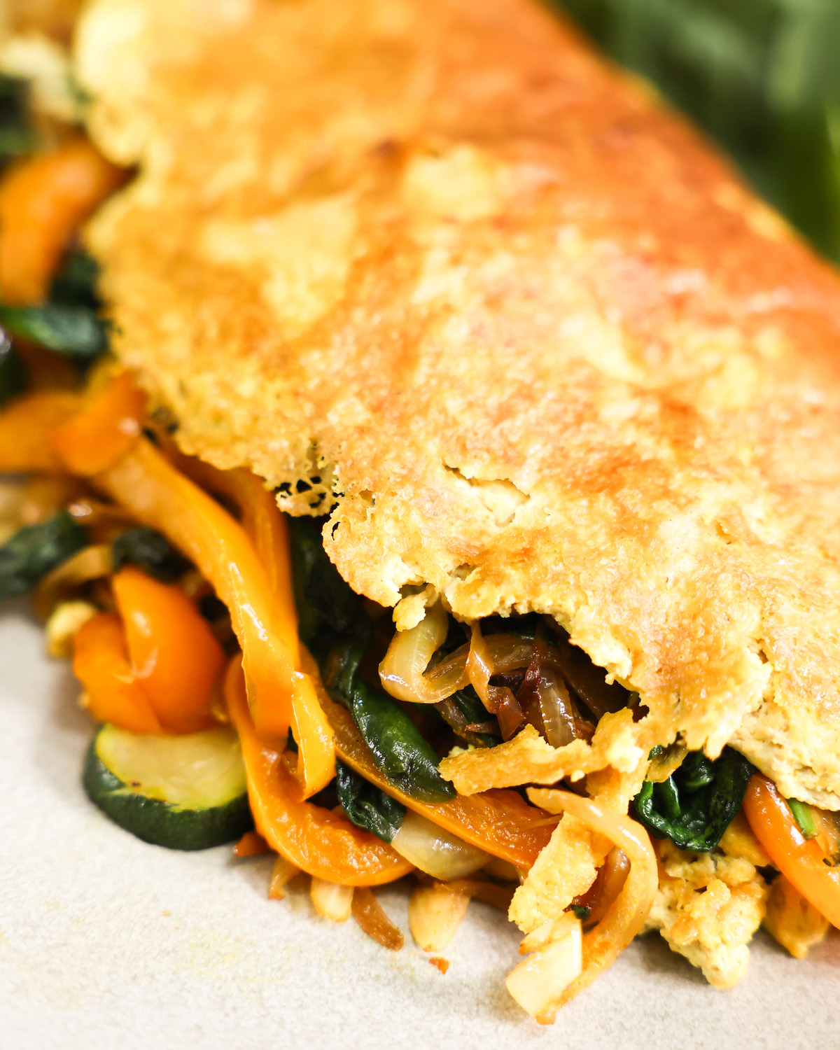 close up vegan omelette stuffed with vegetables