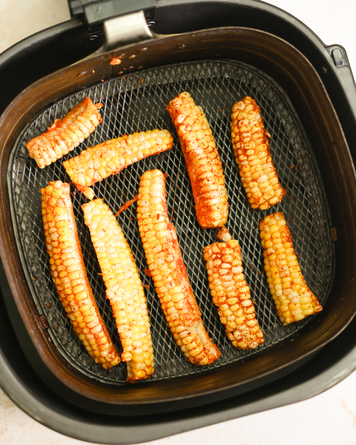 corn arranged in air fryer