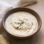 vegan sour cream in a bowl topped with dill