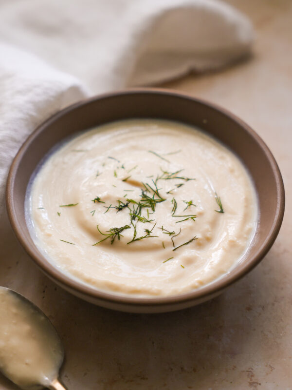 vegan sour cream in a bowl topped with dill