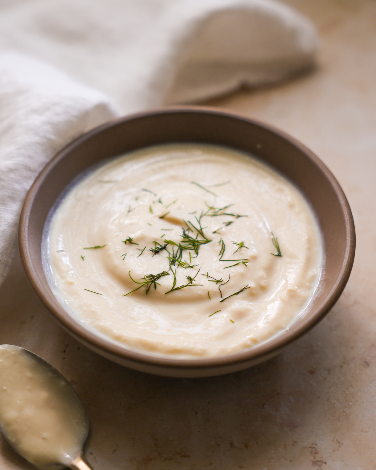 vegan sour cream in a bowl topped with dill