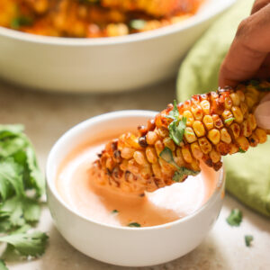 dipping corn ribs in aioli