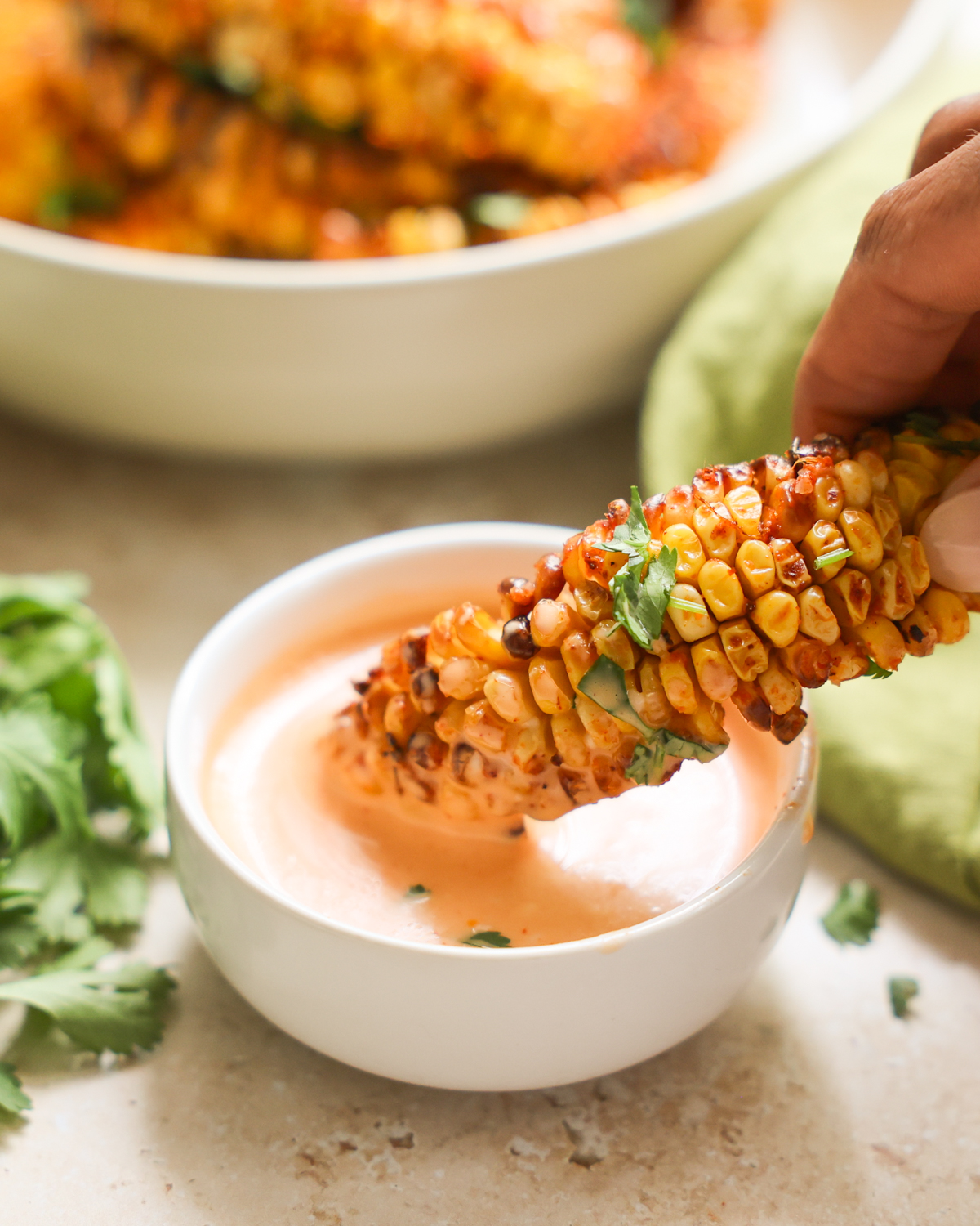 dipping corn ribs in aioli