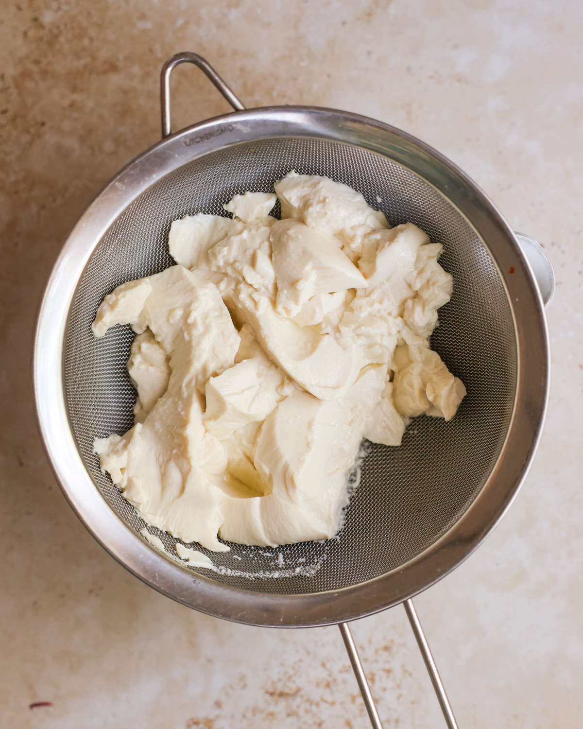 silken tofu draining into bowl