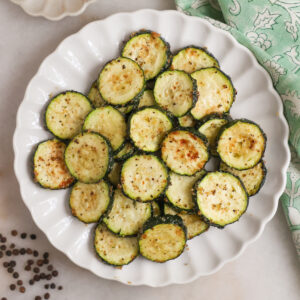 A plate of air fried zucchini on the coutner.
