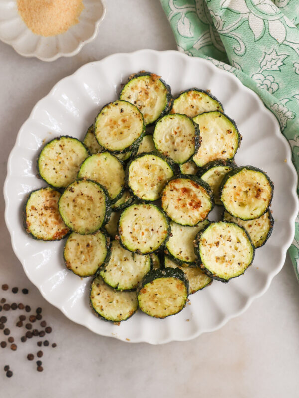 A plate of air fried zucchini on the coutner.