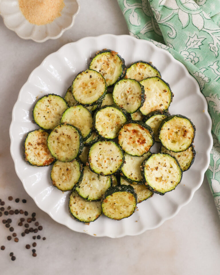A plate of air fried zucchini on the coutner.