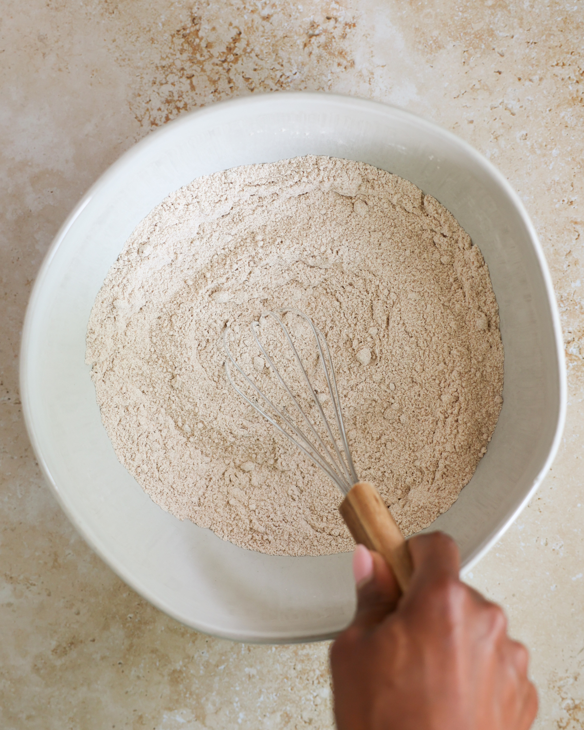 overhead mixing dry ingredients in a bowl
