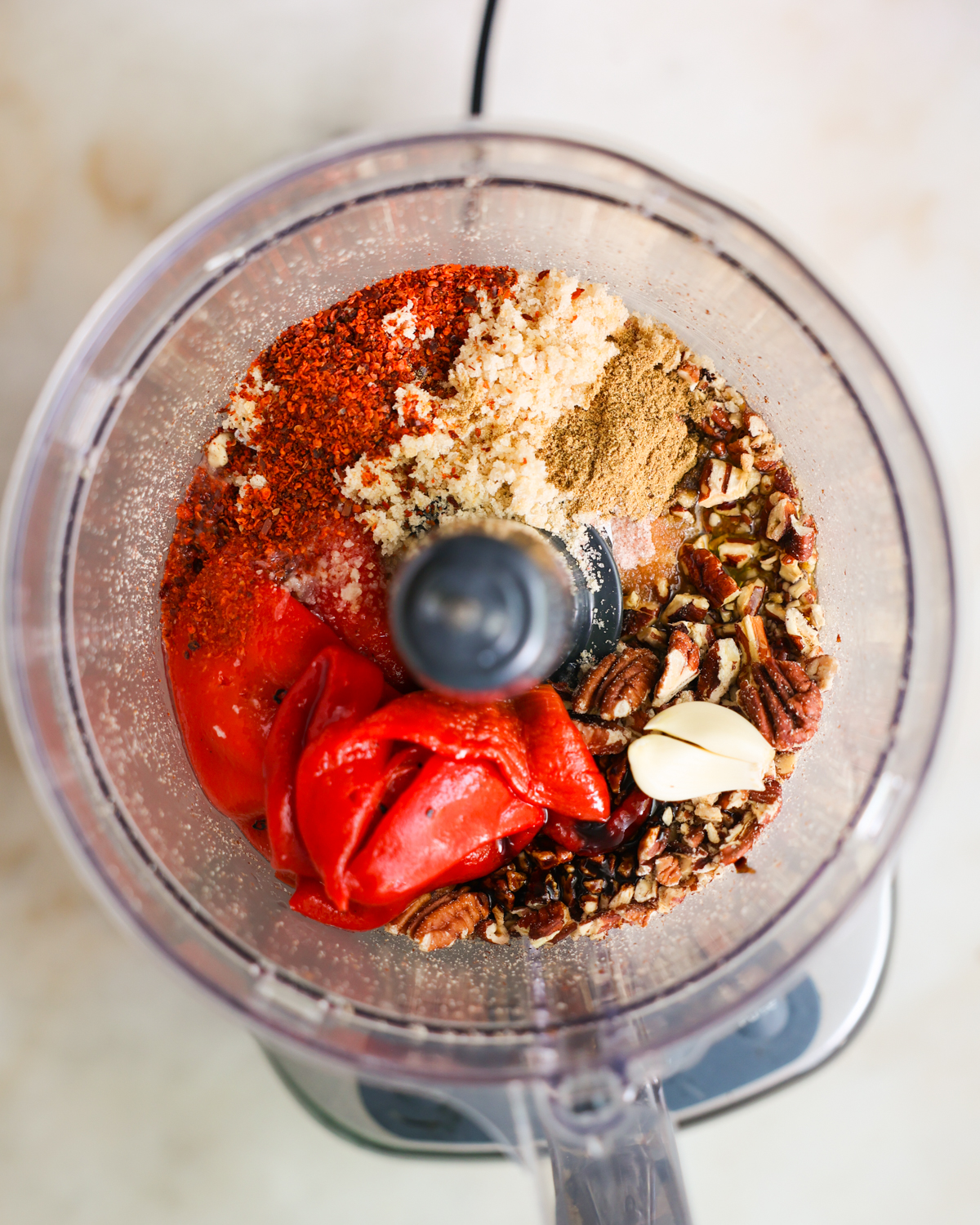 overhead muhammara ingredients in food processor