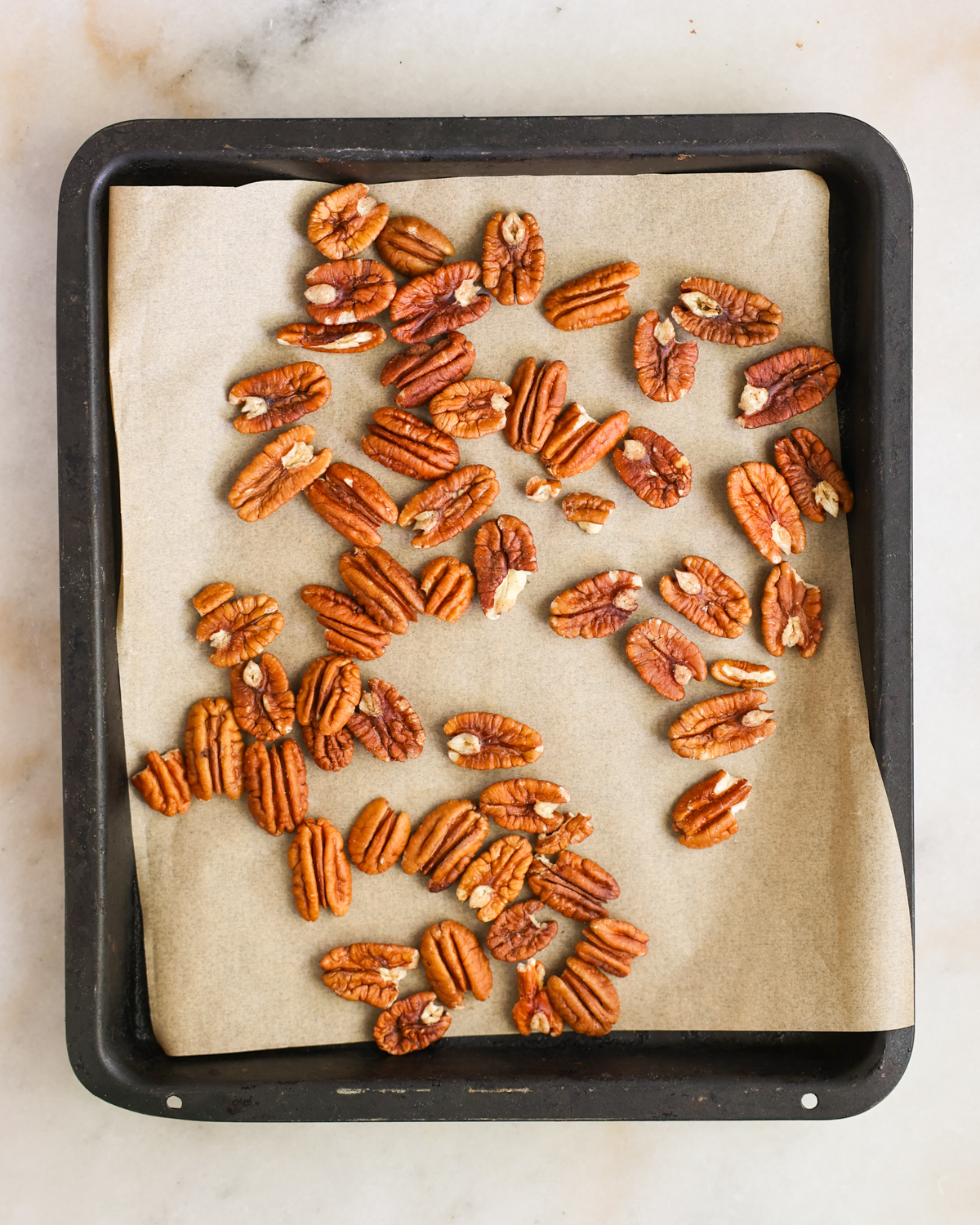 overhead raw nuts on baking sheet
