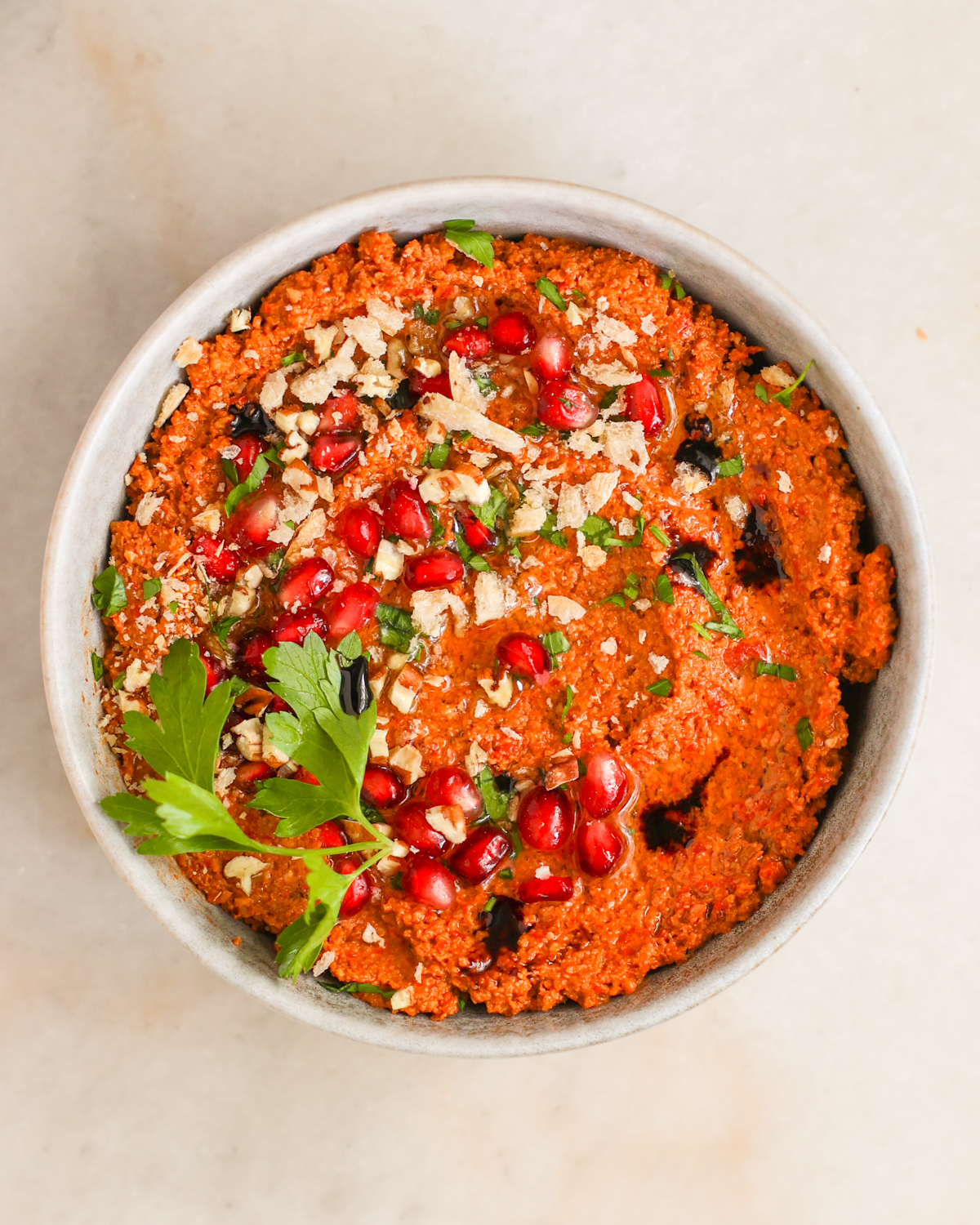 overhead garnished muhammara in bowl