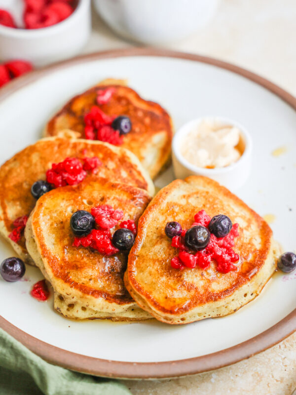 A plate of sourdough discard pancakes with berries.