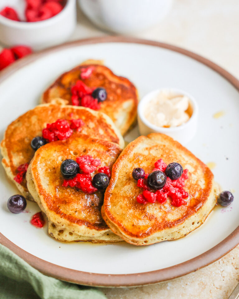 A plate of sourdough discard pancakes with berries.