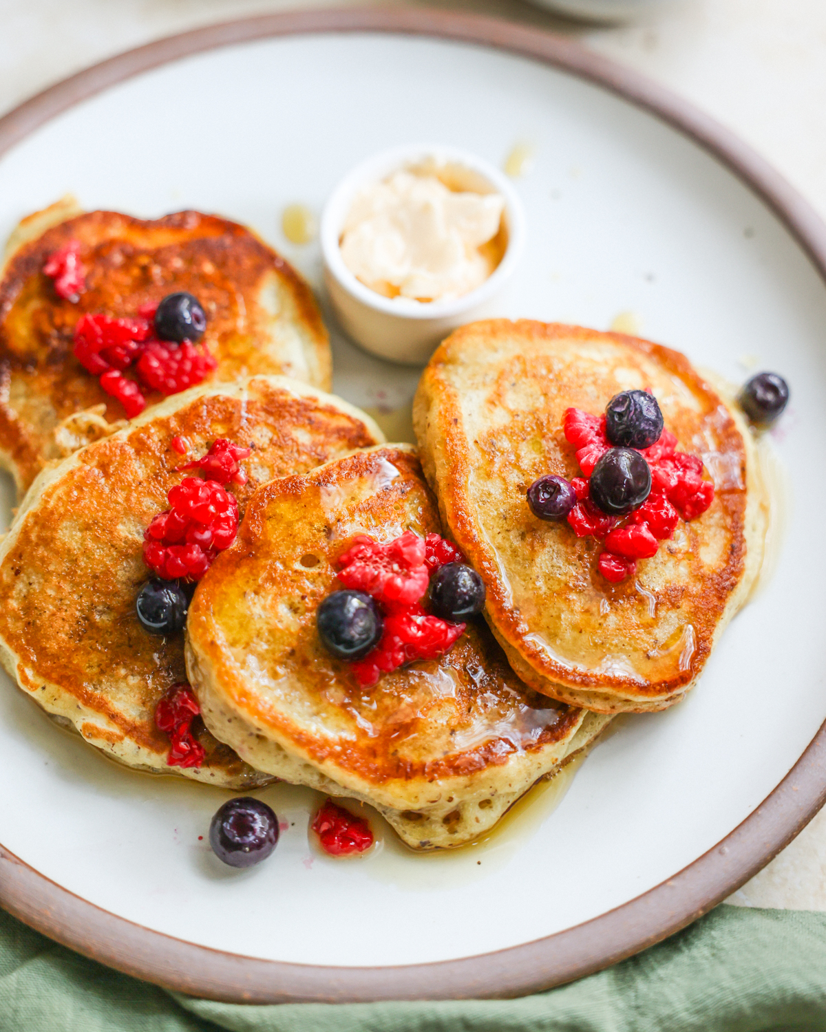 An overhead shot of a plate of sourdough discard pancakes with berries.