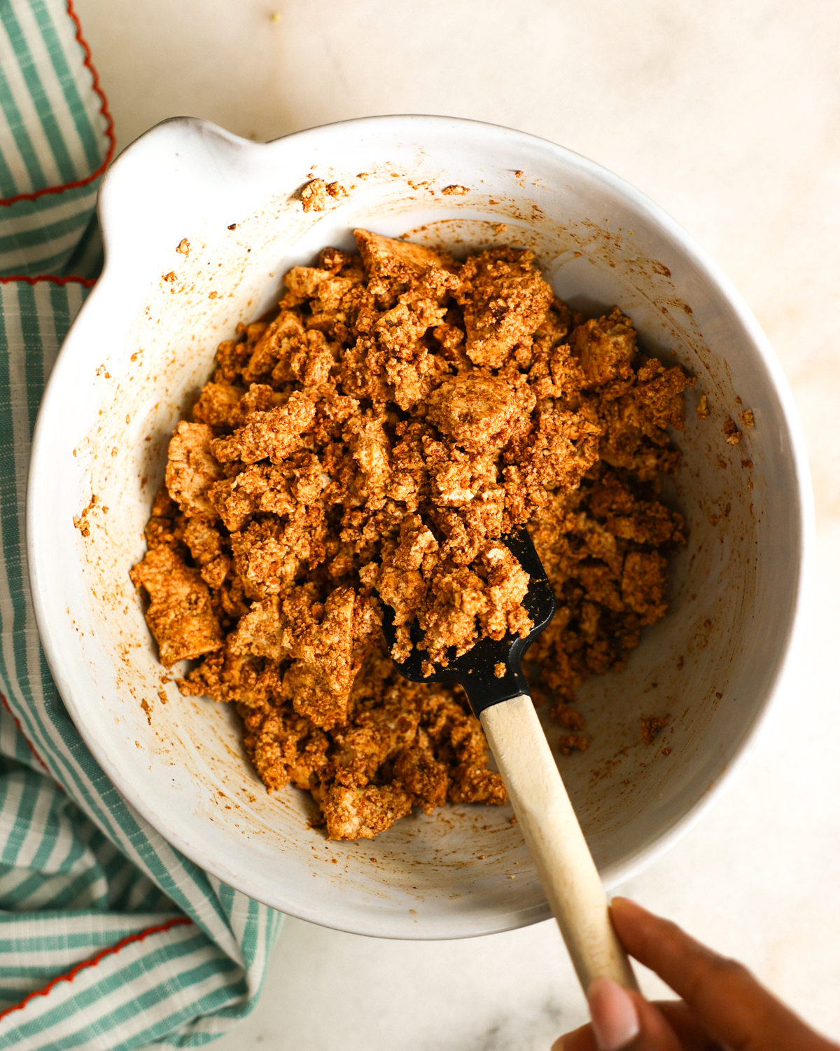 stirring spices into tofu
