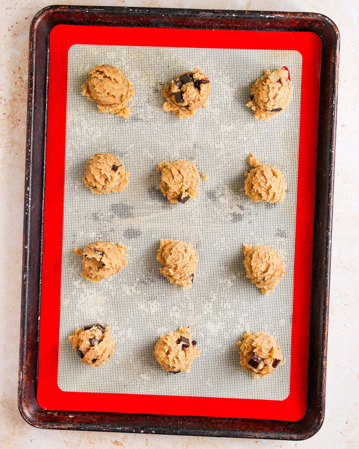 overhead cookie dough balls on baking sheet