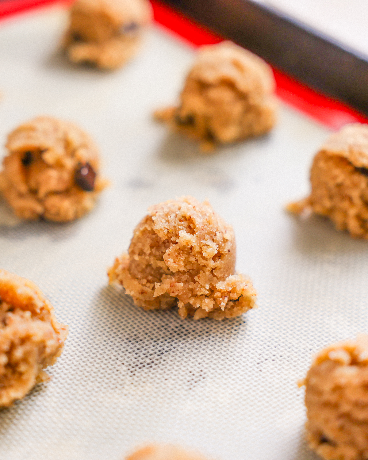 close up of cookie dough on baking sheet